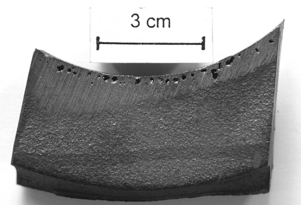 Fig. 2: Dispersed shrinkage (pin holes) in a casting section of nodular graphite cast iron; molding material: furan resin, 80% reclaimed material in the charge