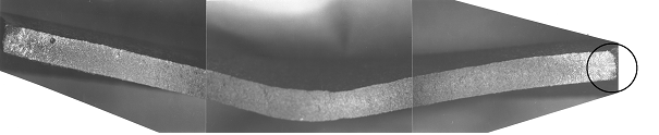 Bild 3: Weißeinstrahlung an einem dünnwandigen Gussteil-abschnitt aus Gusseisen mit Lamellengrafit infolge zu niedrigen Sättigungsgrades und ungenügender Impfung, Vergrößerung 3:1 