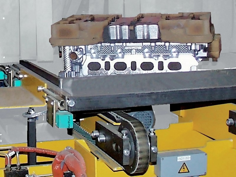 Fig. 2:  Hot castings on transport trays at a transfer station to the cooling line, photo: company Fill GmbH